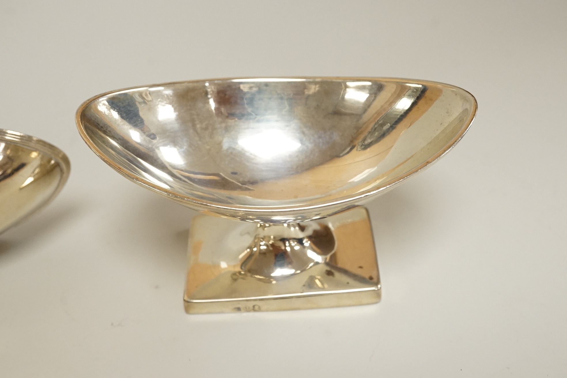 A George III silver pap boat, maker ?? and EB, London 1812, length 12.1 cm, together with a pair of Georgian Scottish silver boat shaped pedestal salts, maker RG, gross weight 7oz.